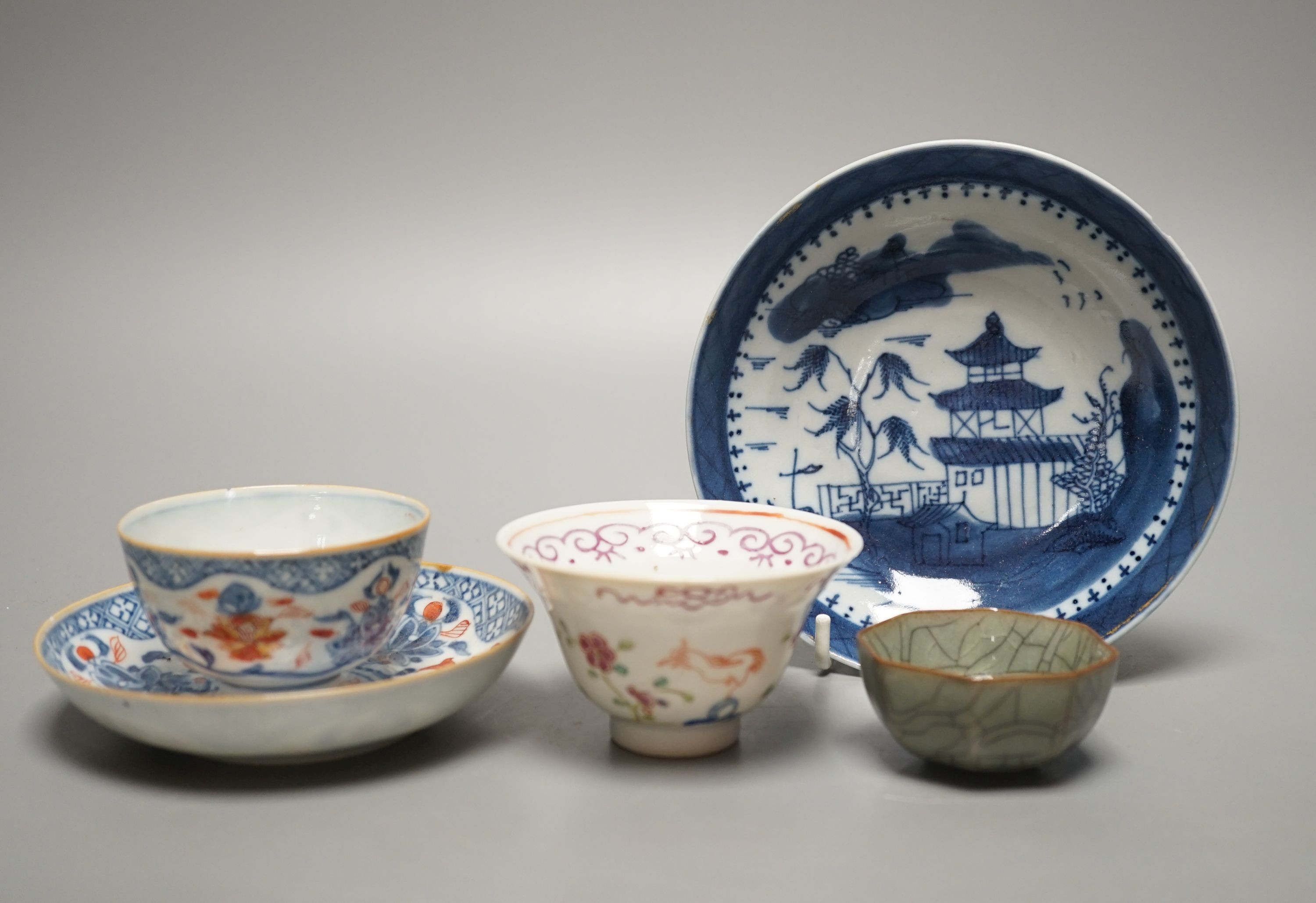 A Chinese Imari tea bowl and saucer, a famille rose tea bowl, a saucer and a celadon glazed cup